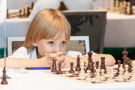 20487182 - young boy playing chess on the competitions