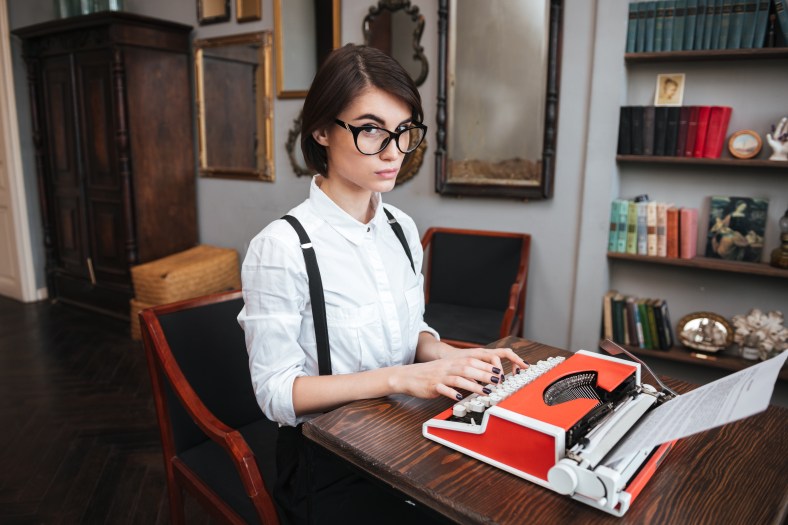 Side view of Authoress using typewriting